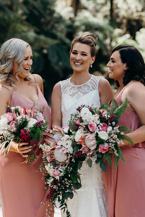 Bride and bridesmaids holding native flowers for wedding