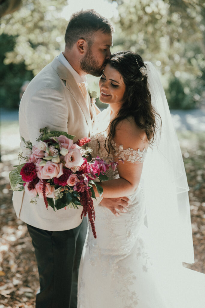 Happy couple with fresh wedding flowers